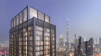 DIFC: a glass tower with the Burj Khalifa and the Downtown skyline behind